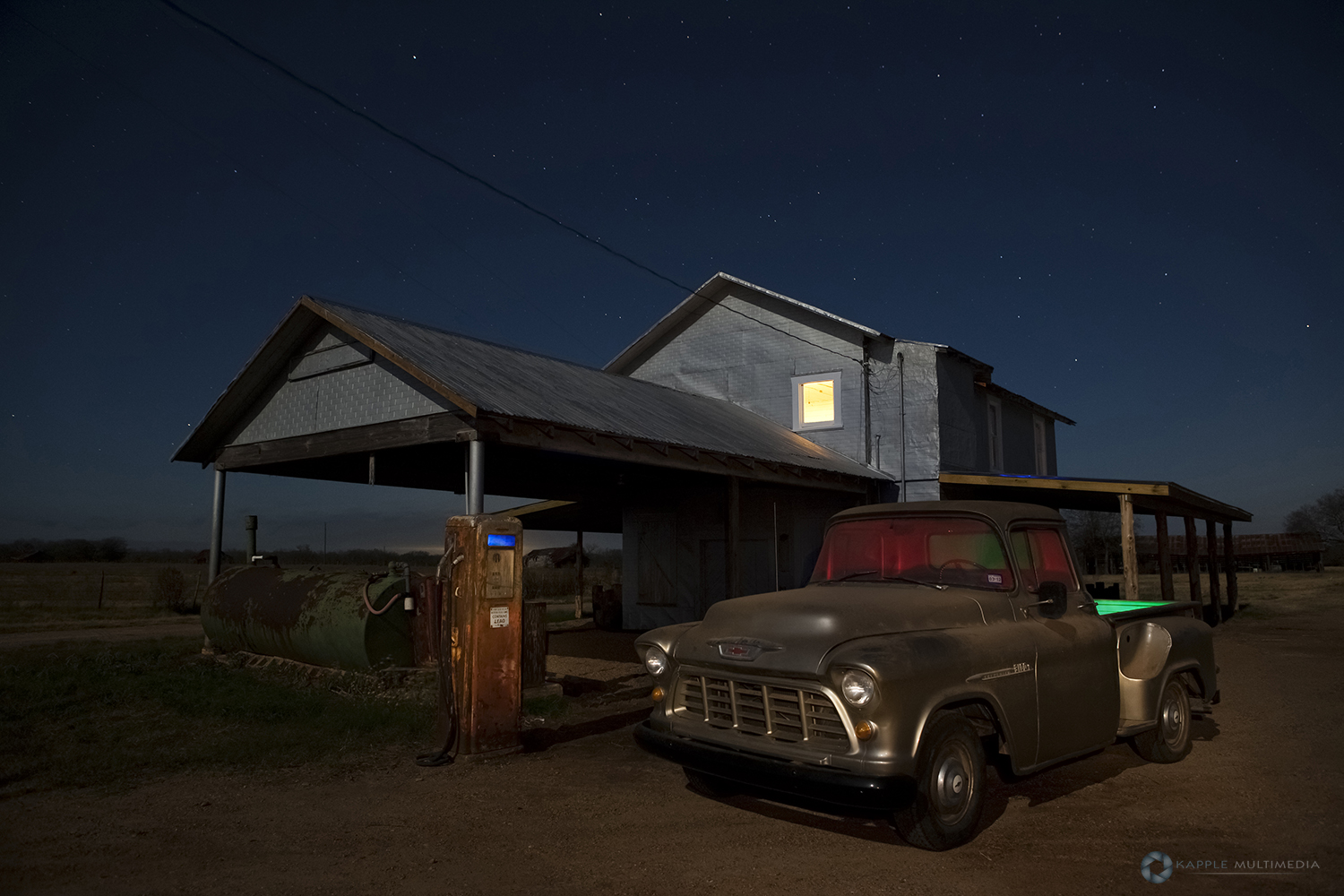 Abandoned Old retro gas station pumps and Truck at night, west Texas, USA