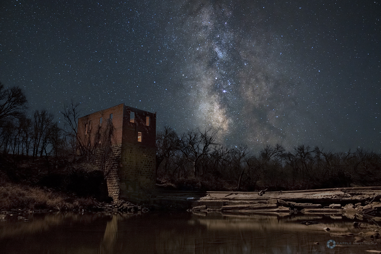 Ruins of an old grist mill lit by moonlight with stars in west Texas